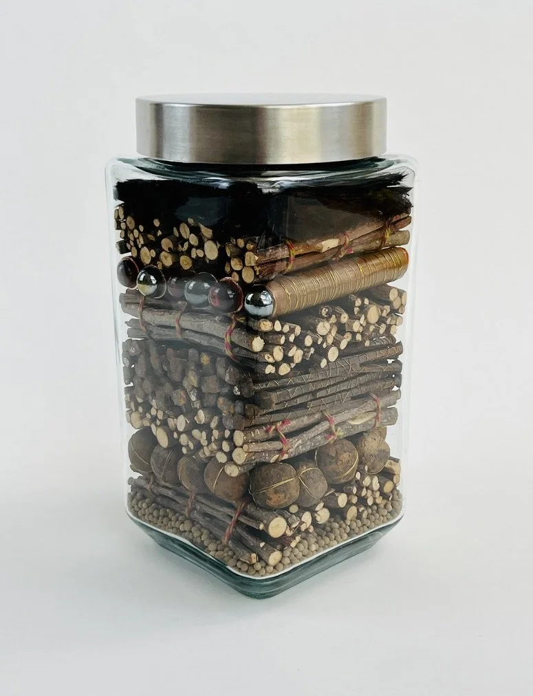 Trifle. 2026 glass, wood, wire, metal, string, feathers, desiccant 8.75 x 4.5 x 4.5