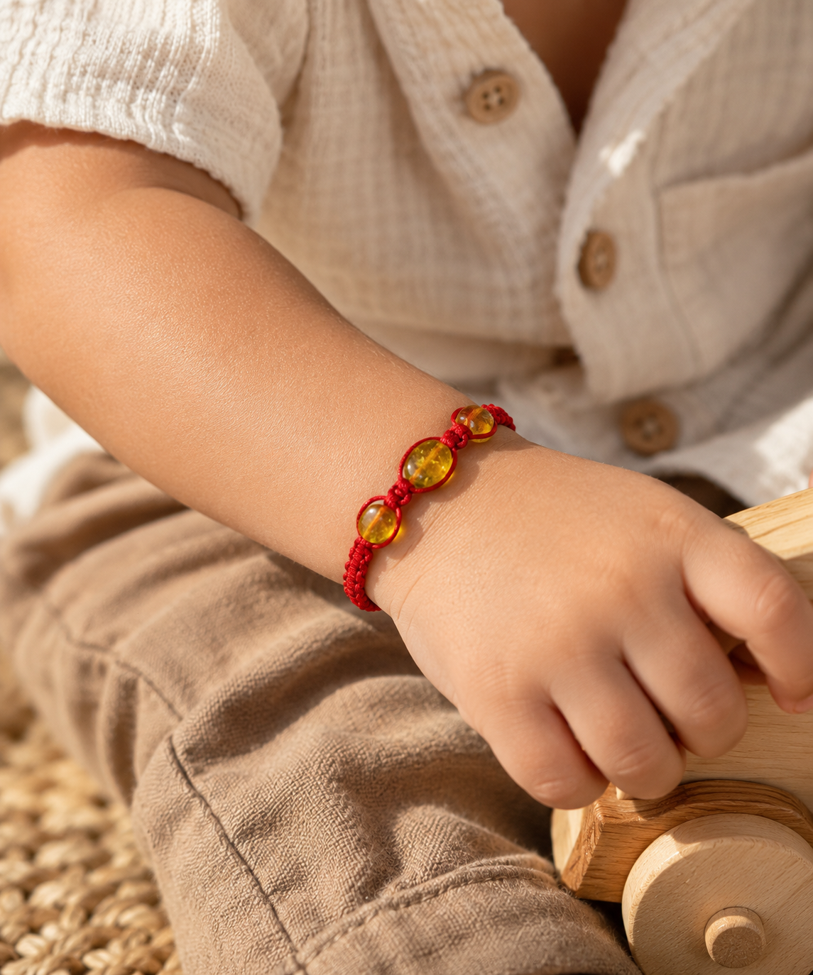 Child’s Amber Bracelet and Wooden Toy.png