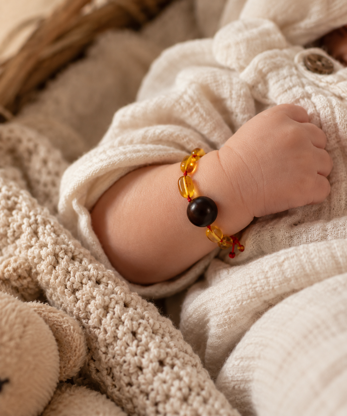 Newborn’s Amber Bracelet on Muslin.png