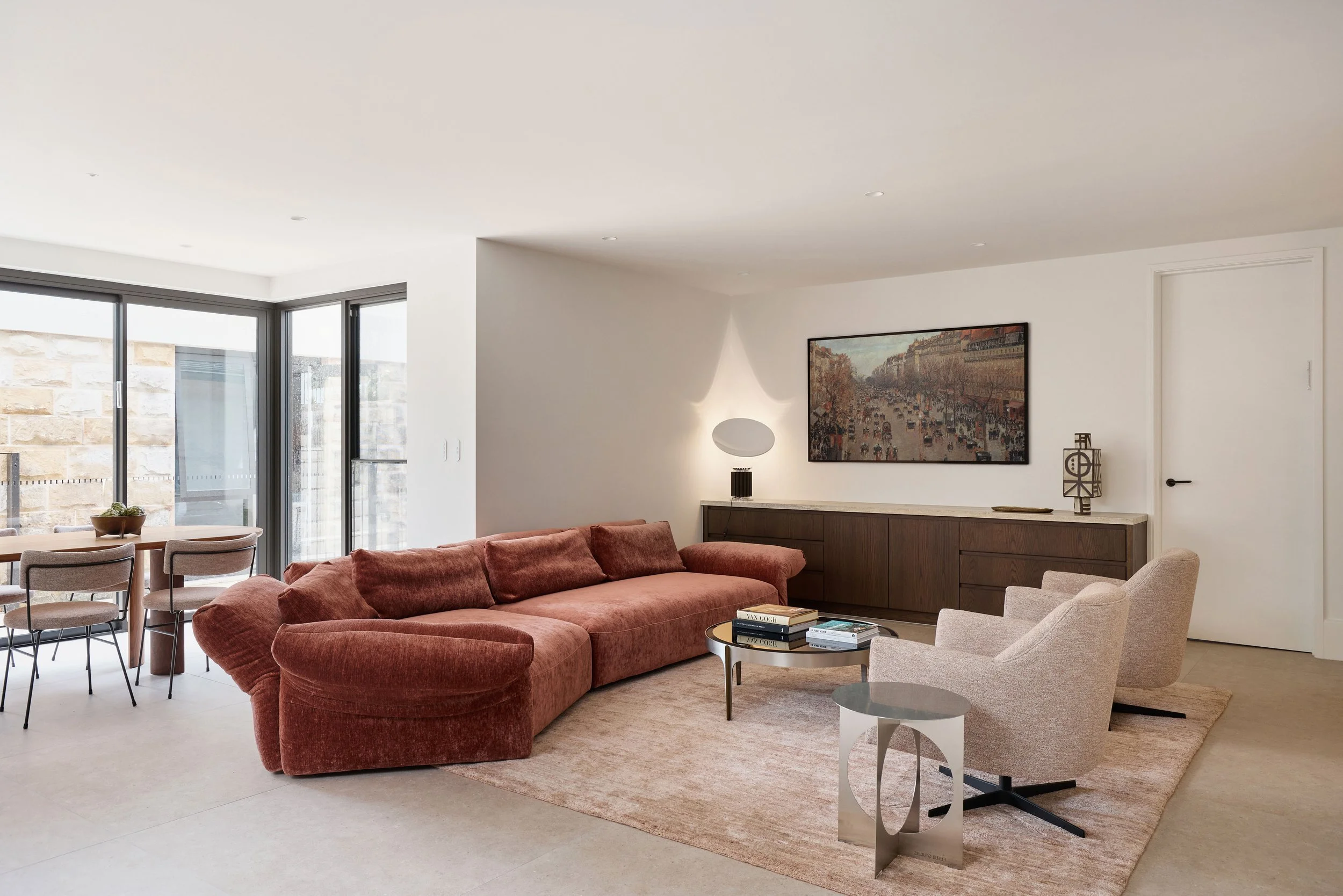 family room with large modular sofa, armchairs and dining area