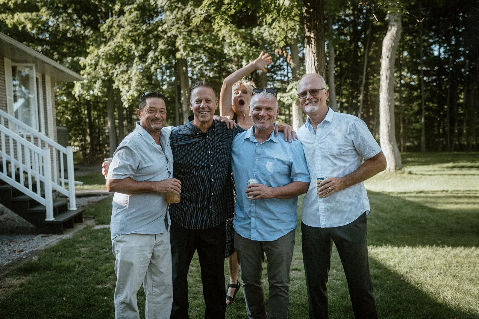 Backyard wedding in toronto where guests are posing for a group photo with silly faces