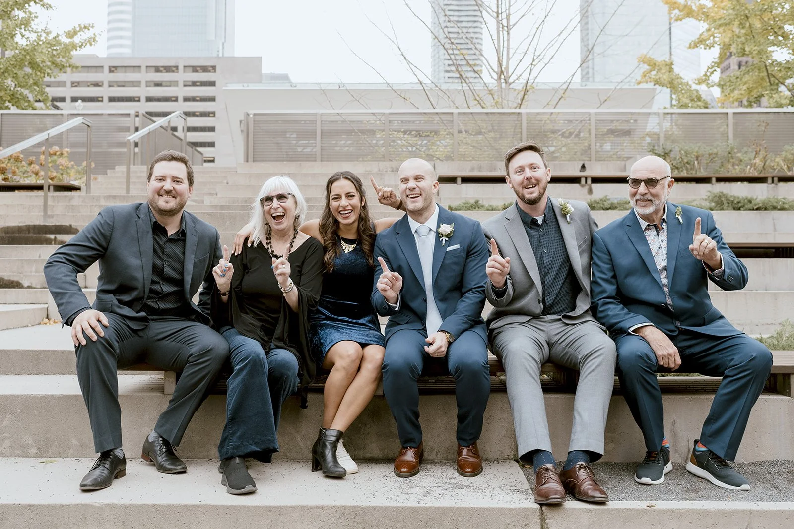 Candid family photo in front of Toronto City Hall after wedding ceremony
