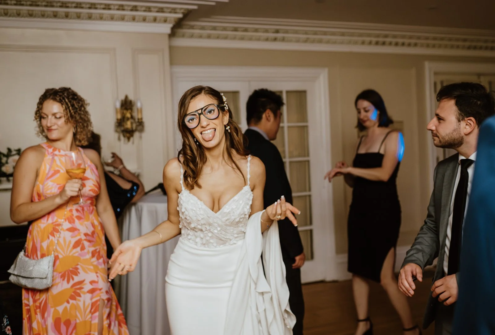 Candid photo of bride dancing with her guests and having fun after small wedding ceremony in Toronto