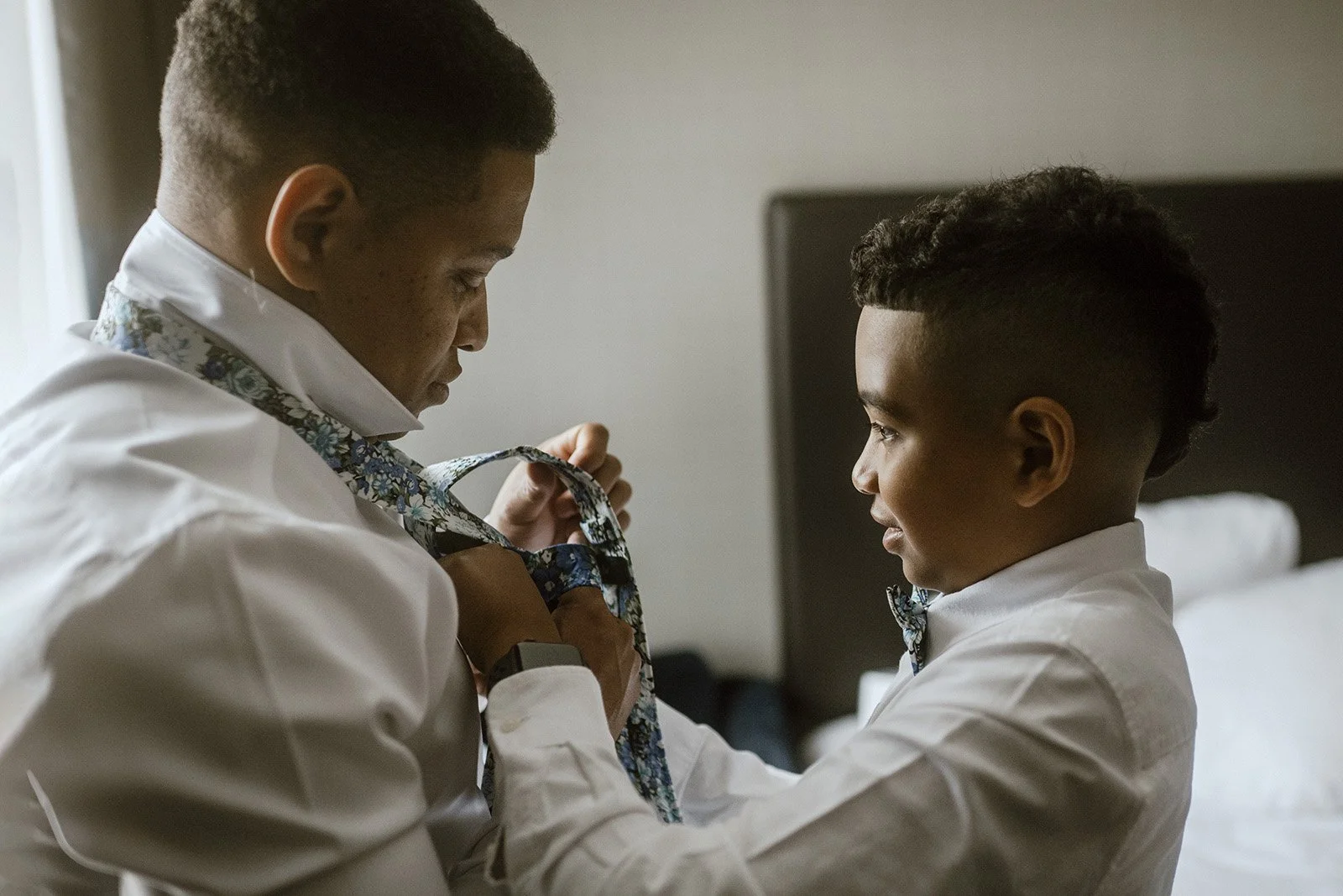 toronto hotel room where the groom's son is helping him get ready for the wedding