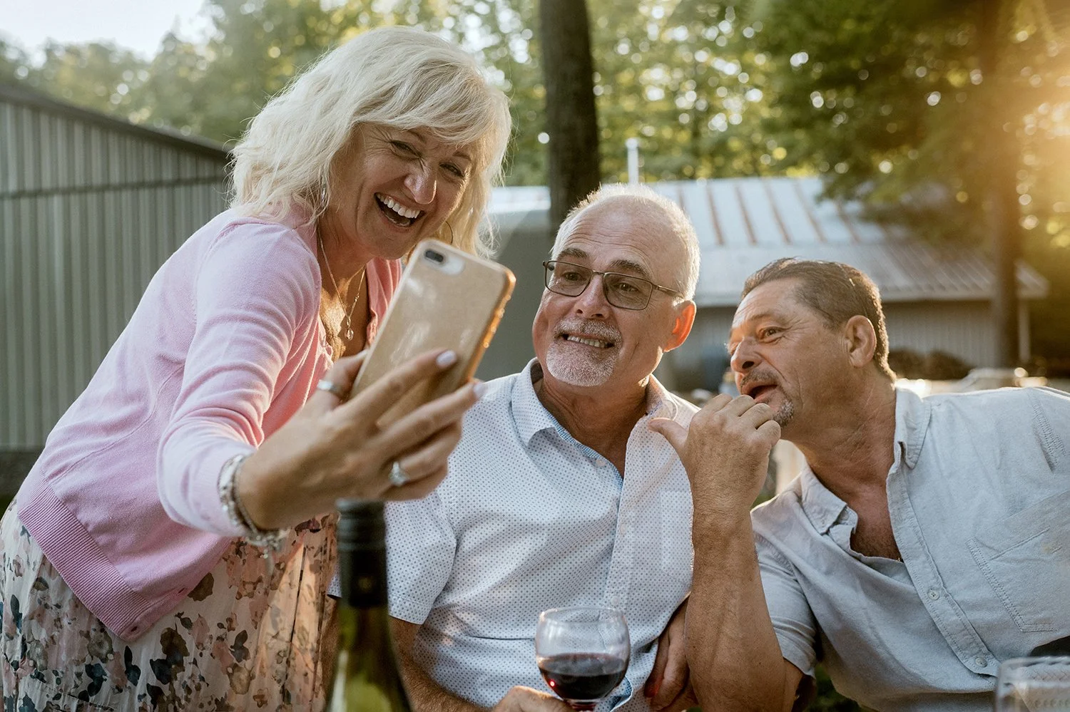 Candid photo of guests having fun on facetime after micro wedding ceremony