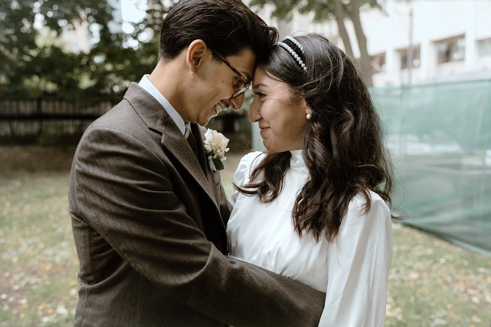 A photo taken in the courtyard of Toronto City Hall of the bride and groom after their wedding ceremony