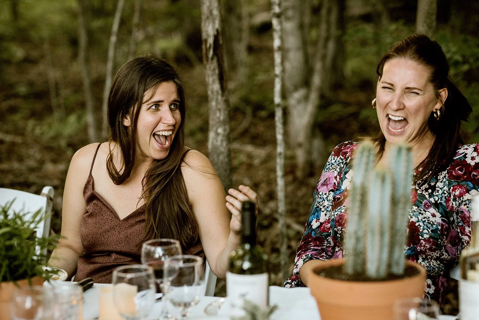 candid photo of guests laughing during the speeches at a micro wedding in a toronto backyard
