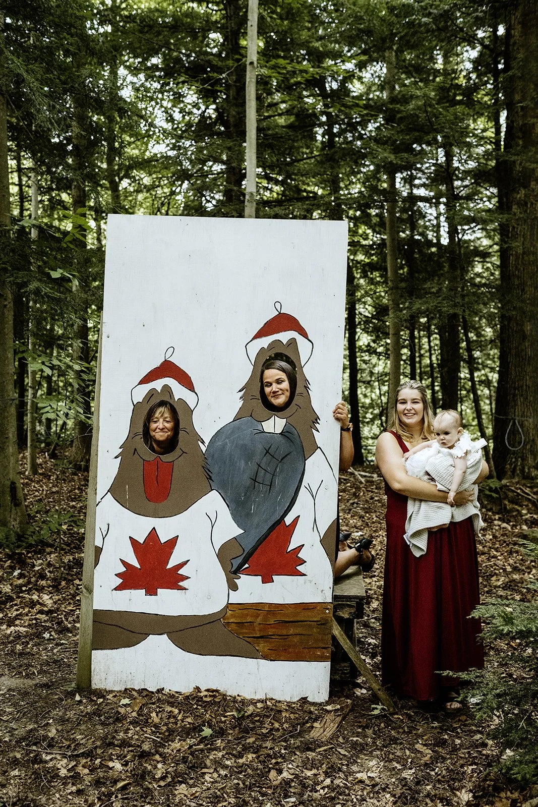 Guests at a small wedding in toronto posing with a cardboard cut and having fun in an open field