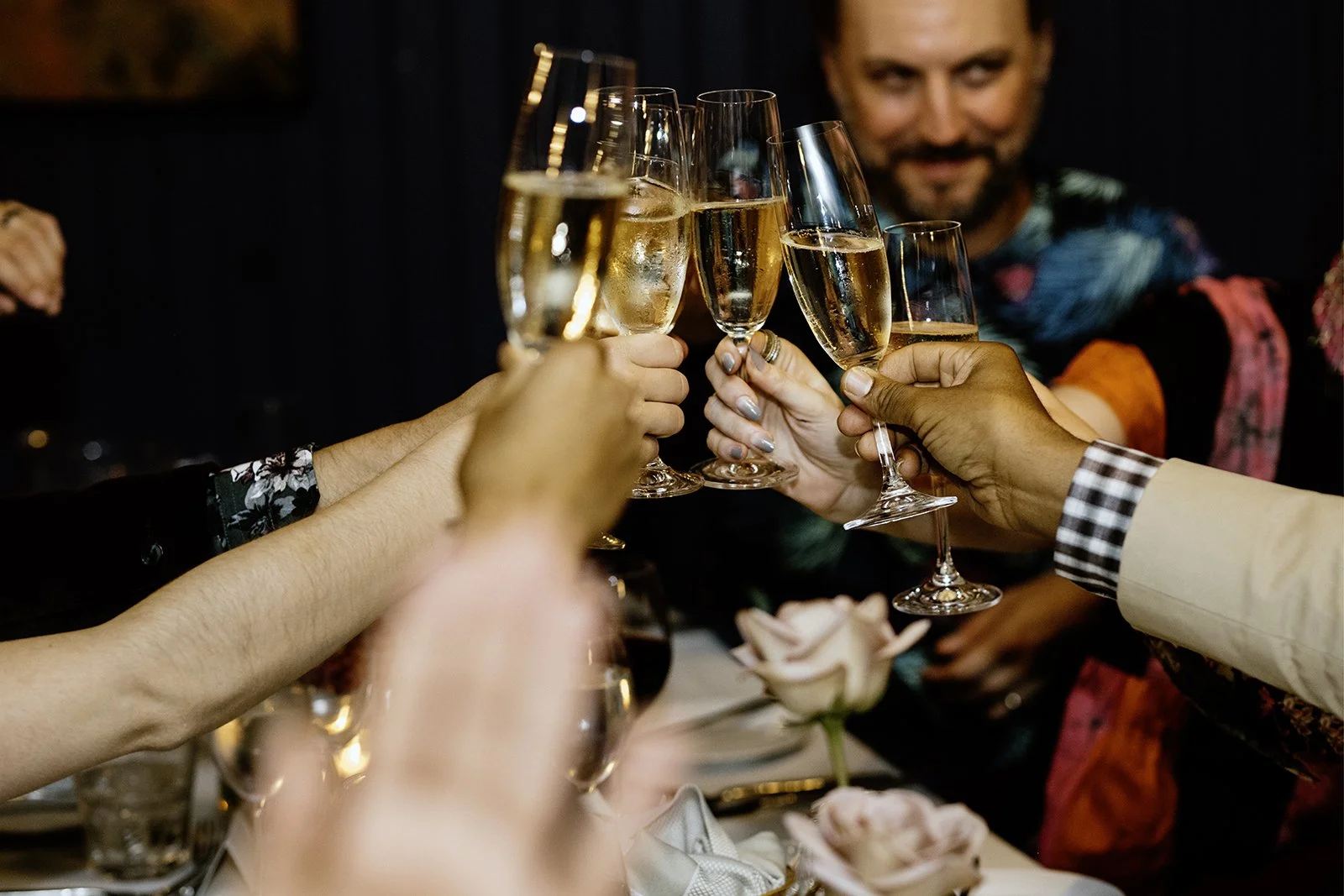 Several people raising glasses of champagne in a toast to the bride and groom at a elopement in toronto