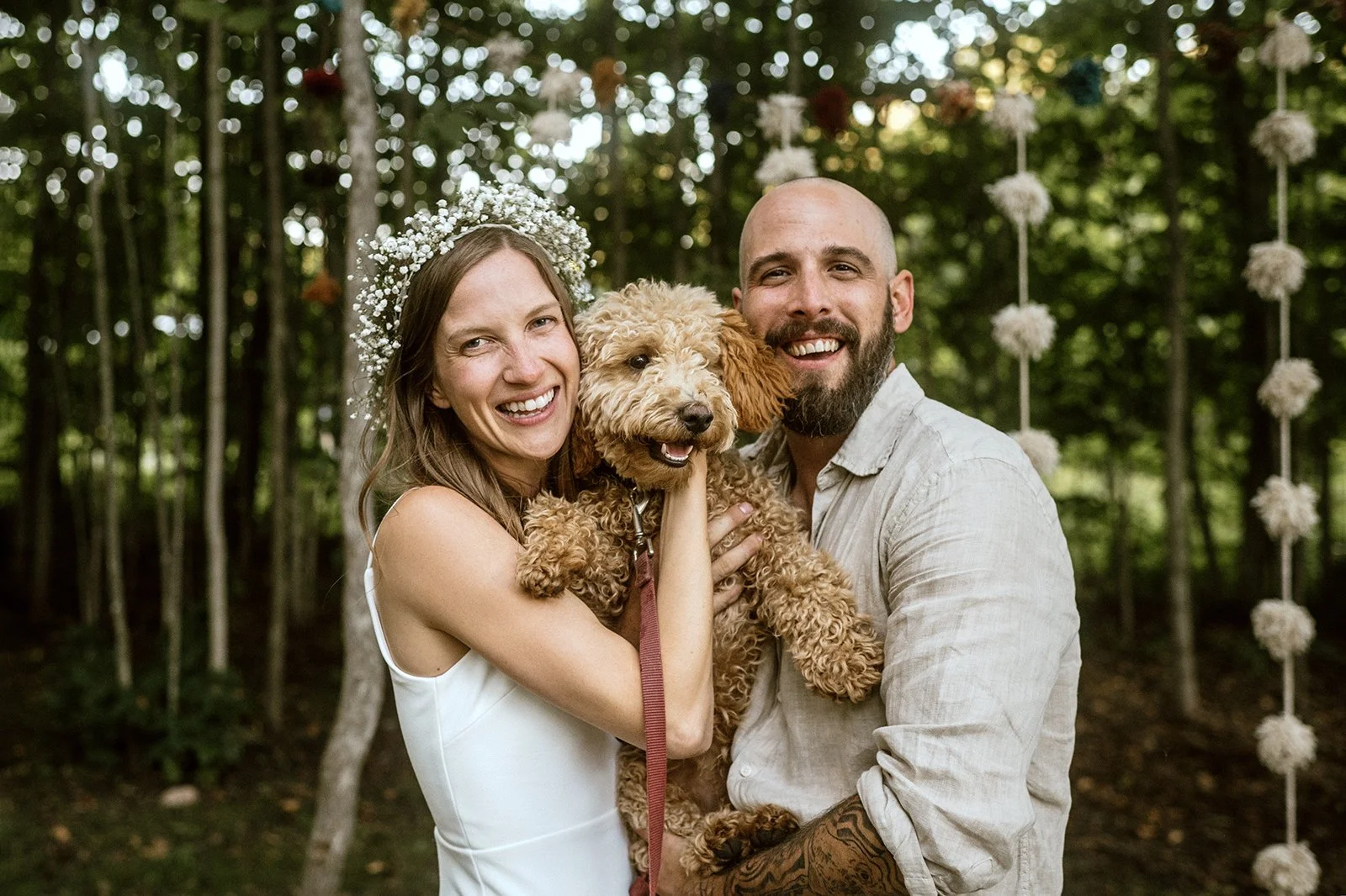 Bride and groom with their dog during their small wedding ceremony in their backyard in toronto