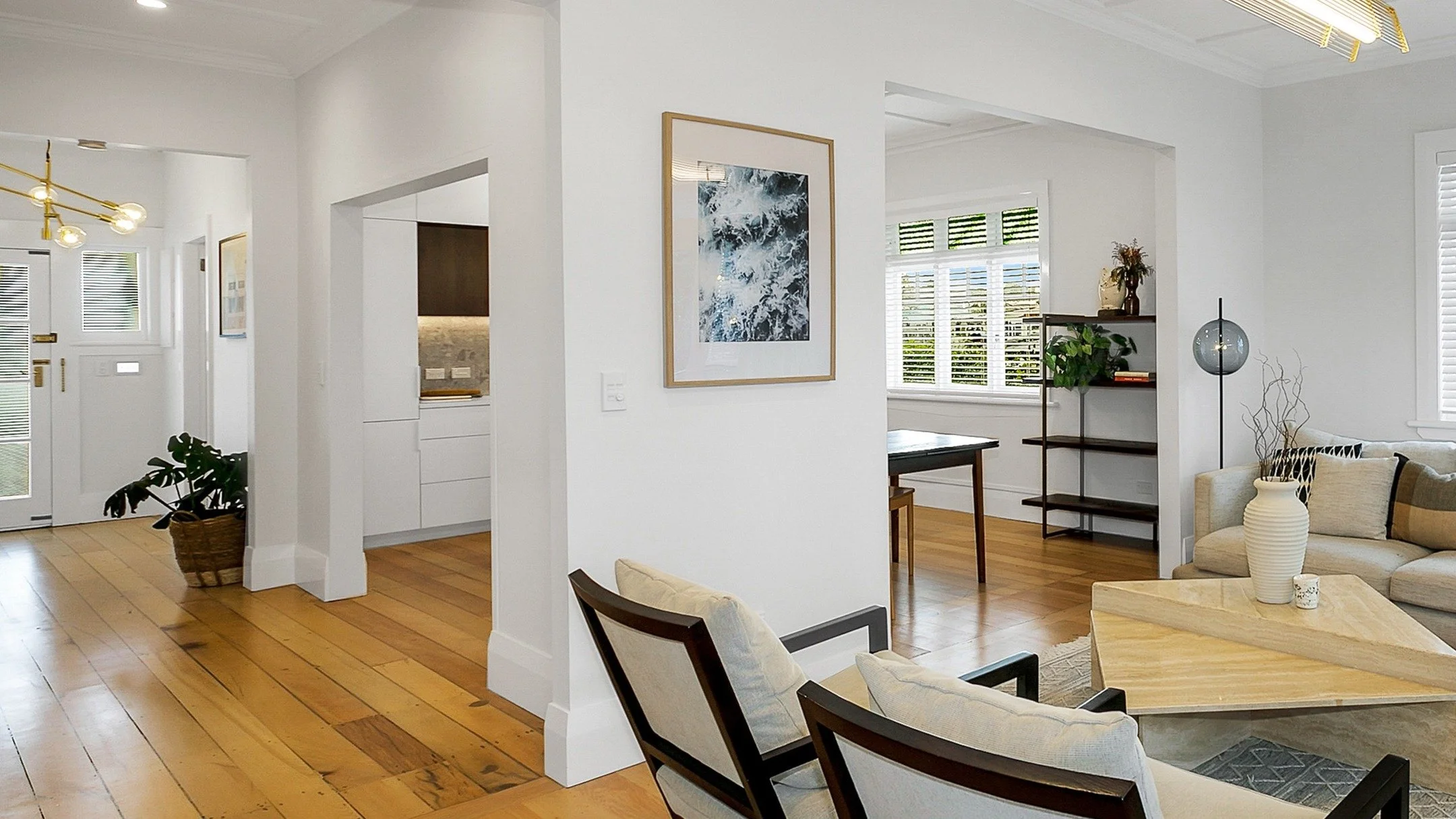 Opening up the walls in this bungalow renovation allowed for a cohesive hallway entrance through to the living and kitchen. Swipe for the before....