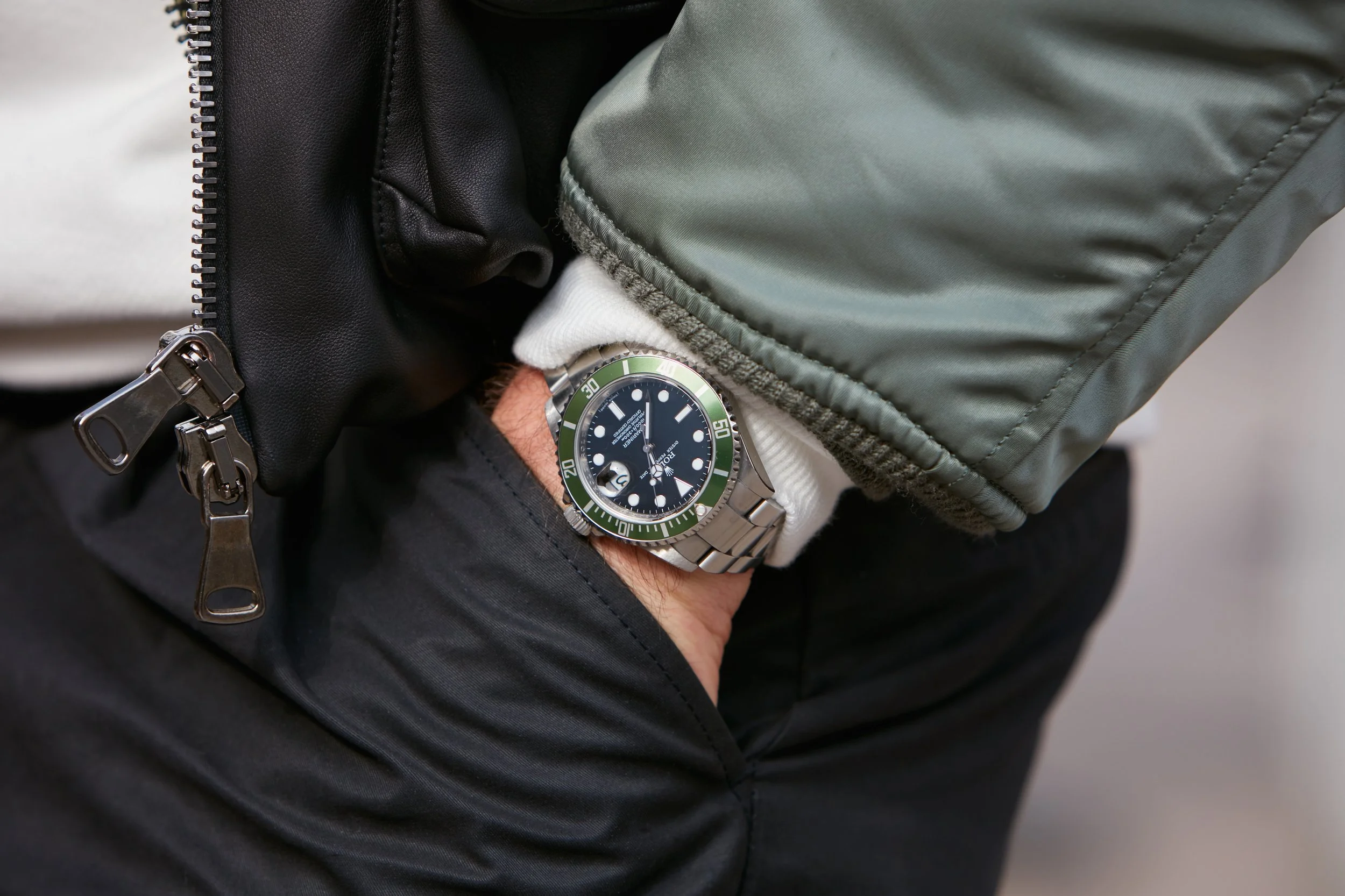 Man wearing a Rolex watch with khaki bevel
