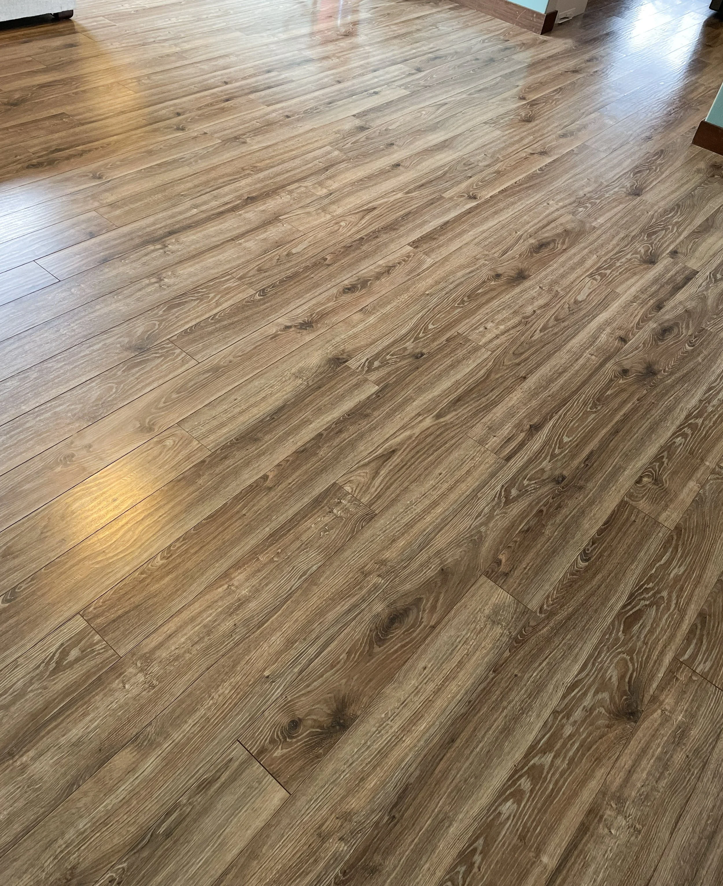 Vinyl plank (LVP) floor with natural wood grain patterns and knots.