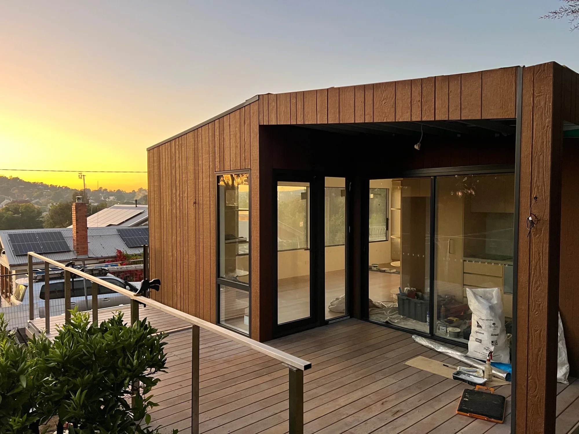 Modular home with timber deck at sunset overlooking Castlemaine, Victoria