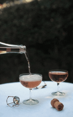 Pouring Sparkling Wine into Couple Glasses