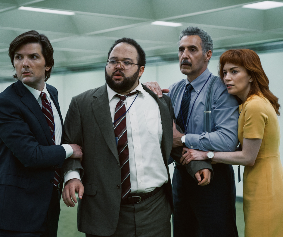Four office workers huddled together in a sterile, green-carpeted hallway, illustrating the "wisdom" of fawning as a strategy for tribal safety and co-regulation.