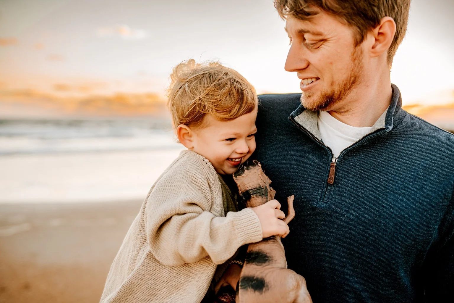 Dr. Clay Celander enjoying the beach with his child