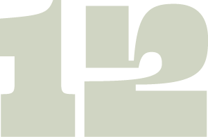 A close-up of a white number 12 on a grey background.