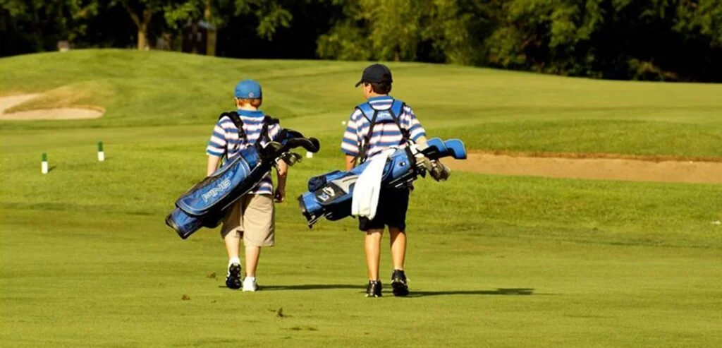 Junior golfers walking on the course