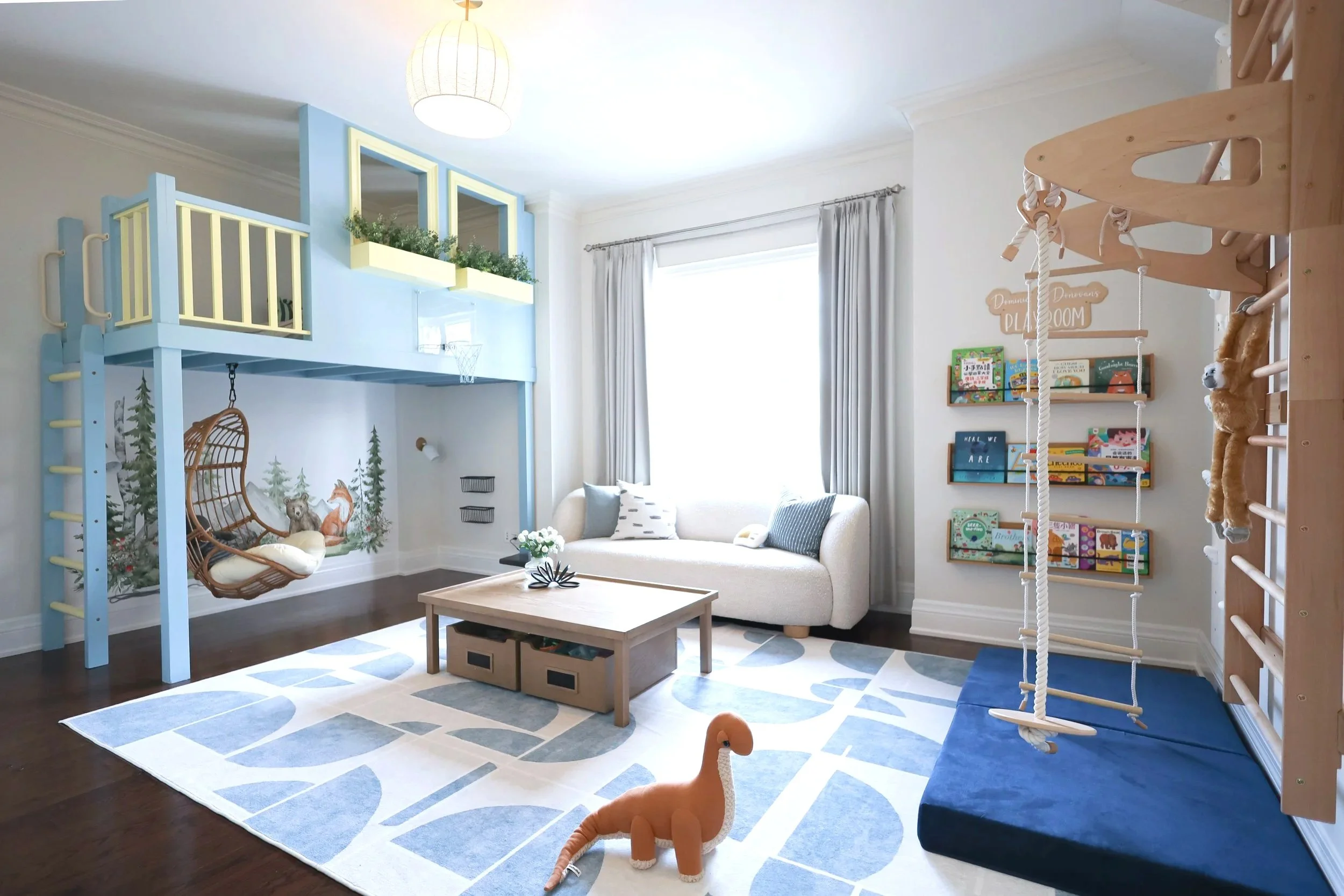 Children's playroom with a loft bed, a hanging chair, a sofa, bookshelf, and a slide and climbing frame, decorated with plush toys and toys.