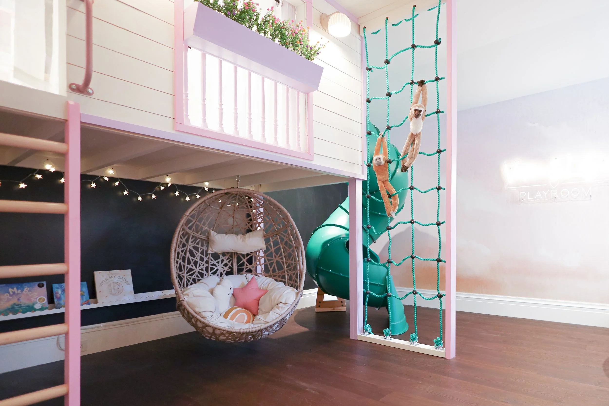 Custom design build playhouse in Rosedale Toronto with swirly slide and egg chair designed by Sophie Shay