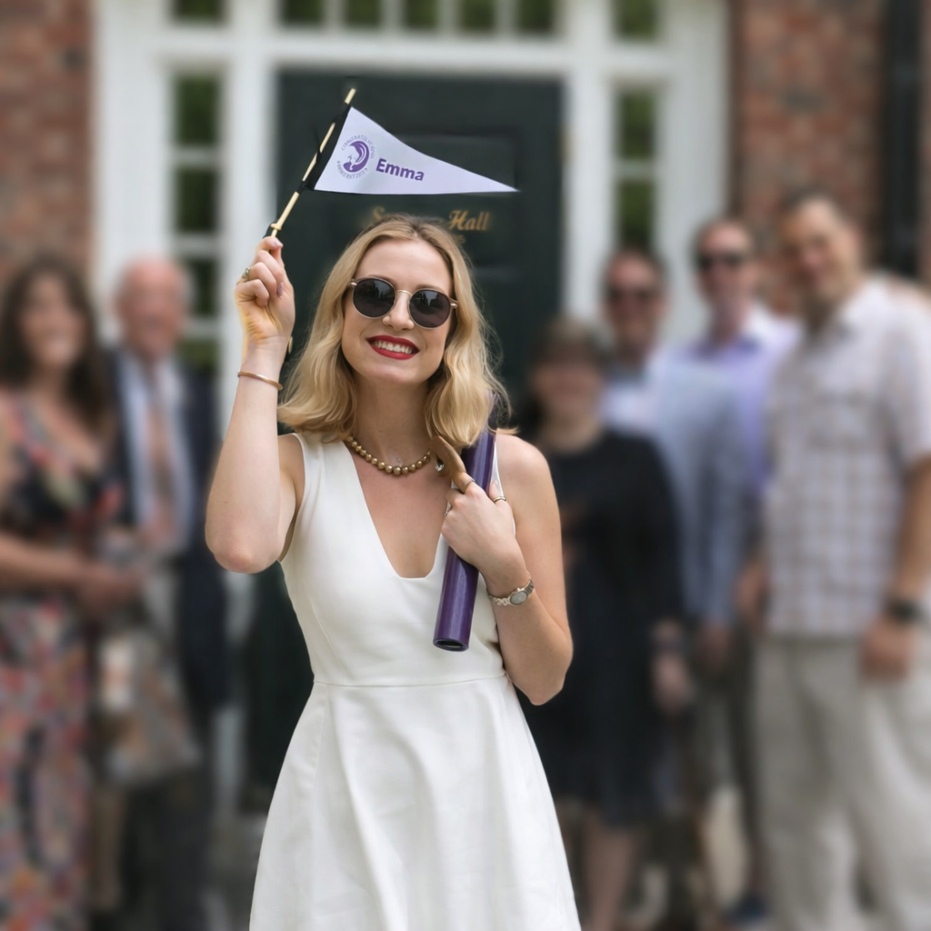 ngratulatory flag for Emma, in front of a house with a black door.