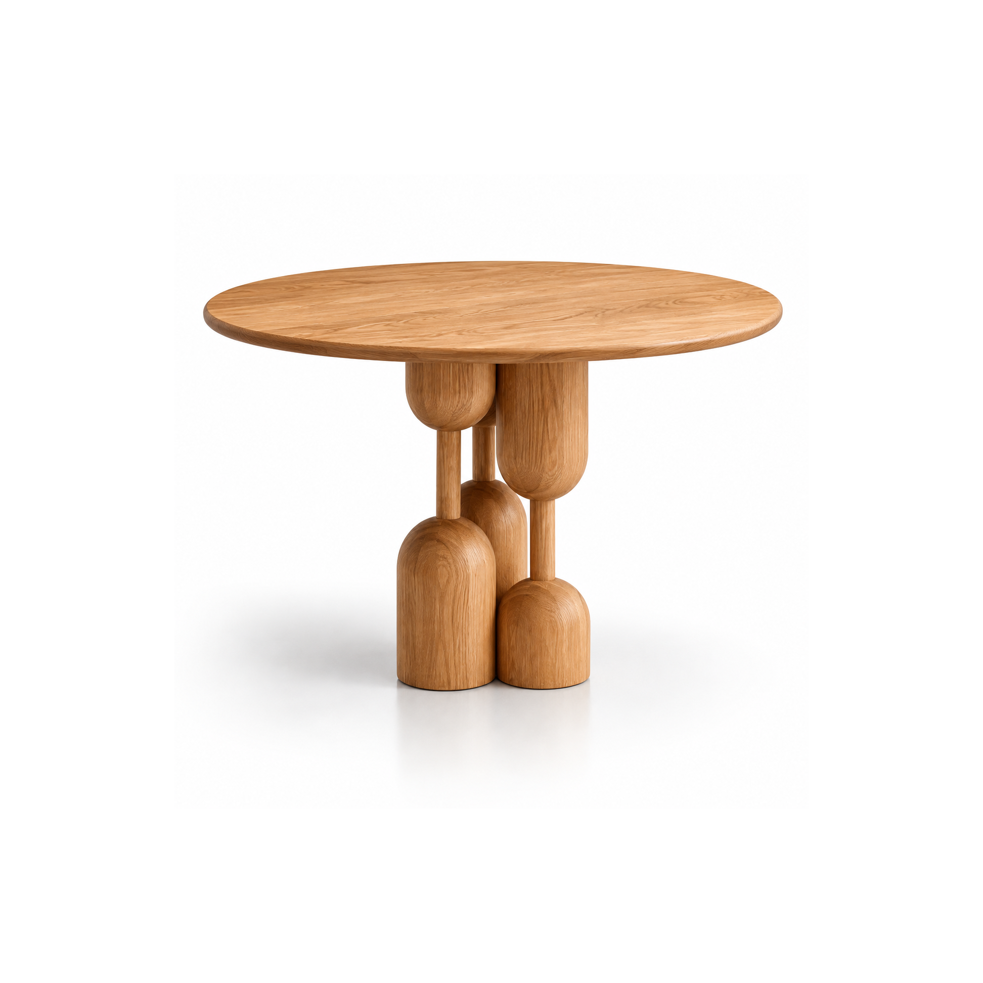 Modern round oak pedestal table with a warm natural wood finish, sculptural pedestal base featuring rounded geometric forms