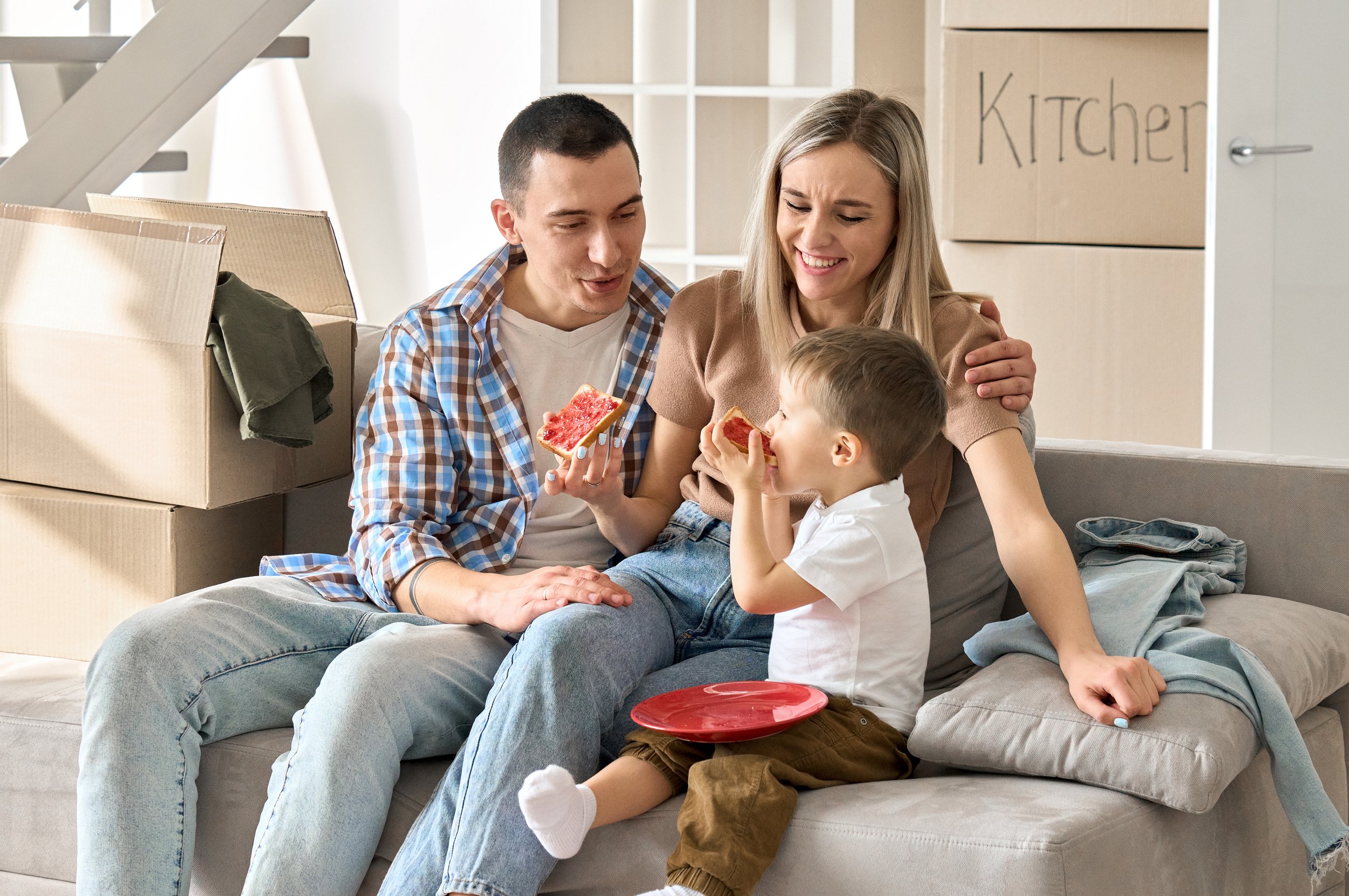 happy-family-new-tenants-with-kid-sitting-on-couch-2021-09-02-15-13-28-utc.jpg