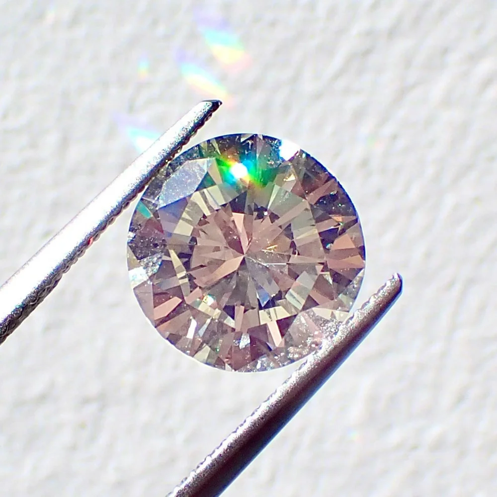 Diamond held in tweezers during a private appraisal