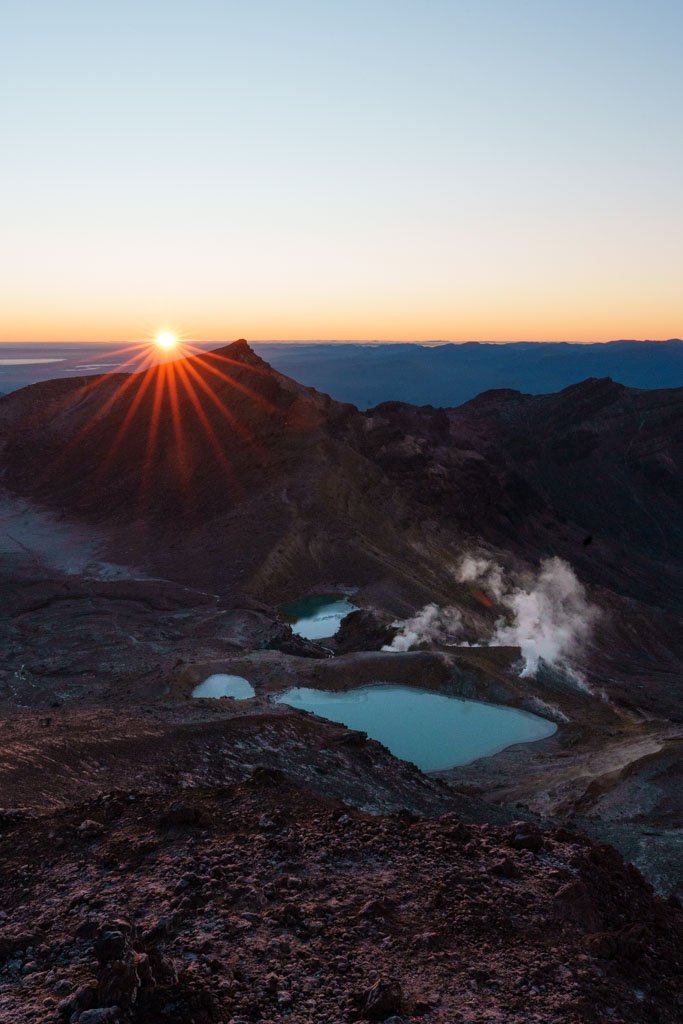 The sun rises over the emerald lakes on the Tongariro Crossing