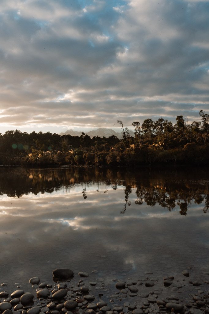 The Southern Alps are reflected in still water