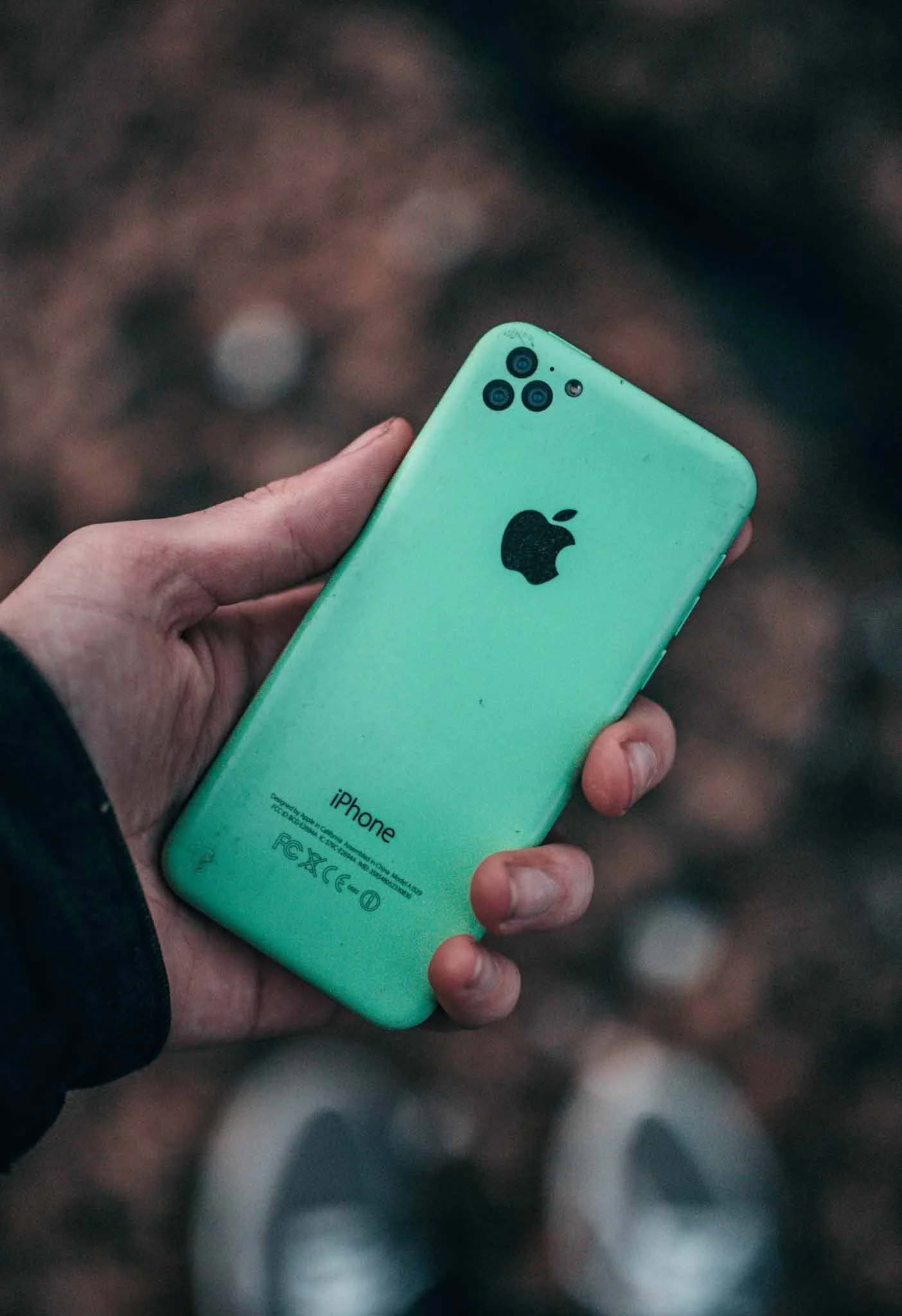 a person holding a green iphone in new zealand
