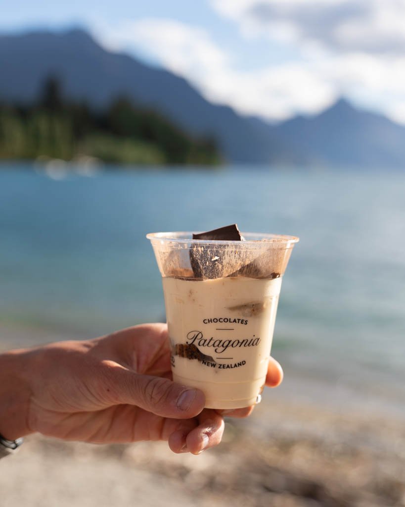 A hand holding a tub of tiramisu from boutique chocolate shop Patagonia Chocolates in Queenstown