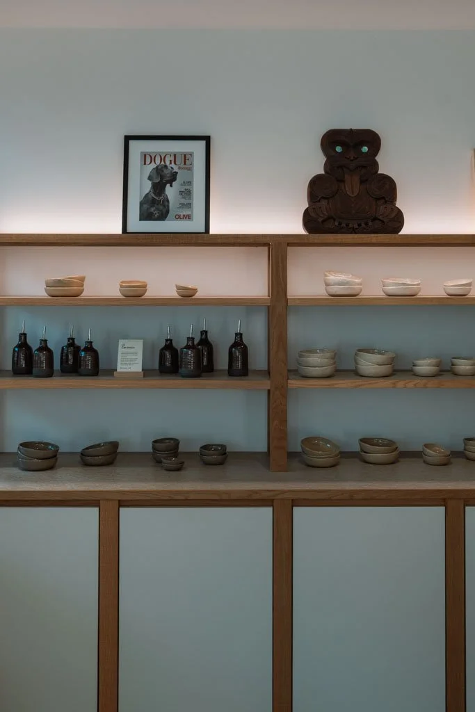 Shelves lined with ceramics and artworks