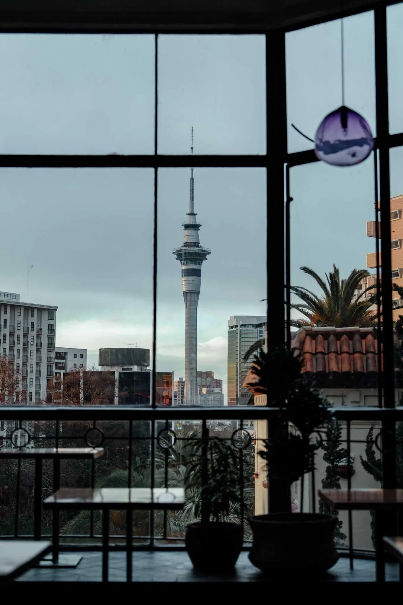 A view of the Sky Tower through the windows of Saint Kevins Arcade on Karangahape Road
