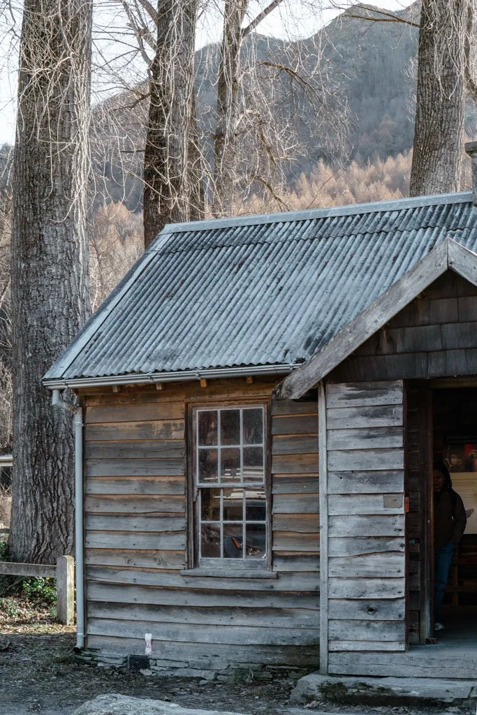 An old wooden building surrounded by bare trees