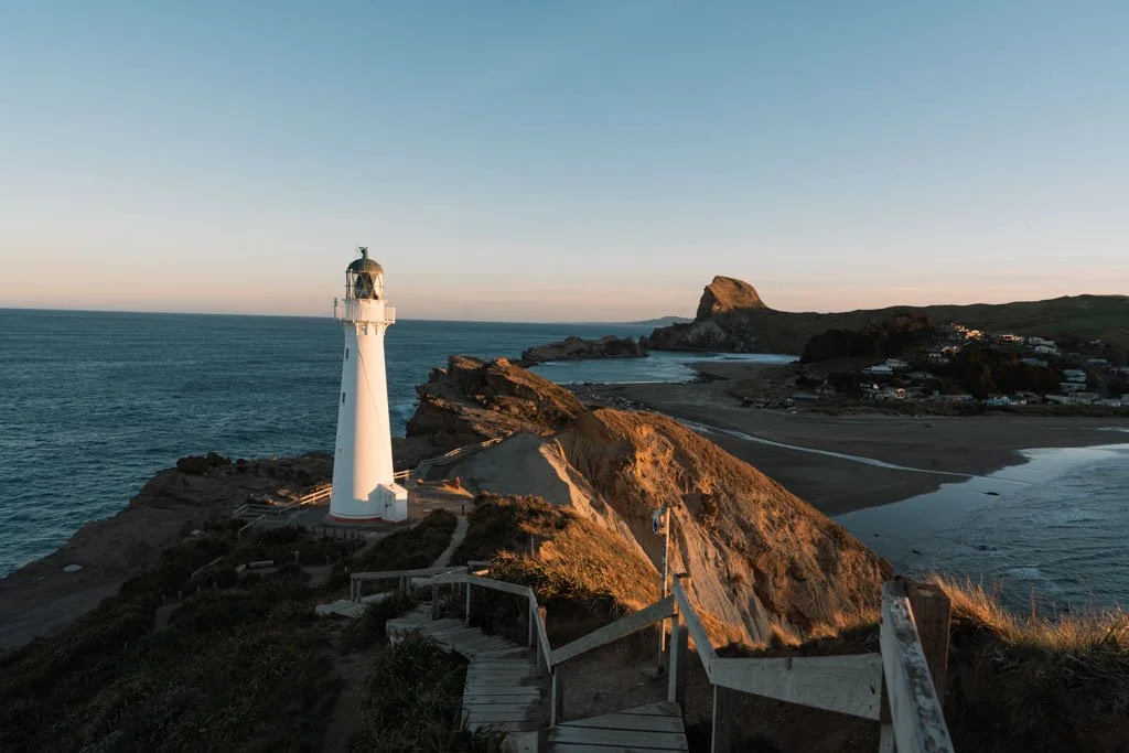 A lighthouse sits on a rocky outcrop at Castlepoint