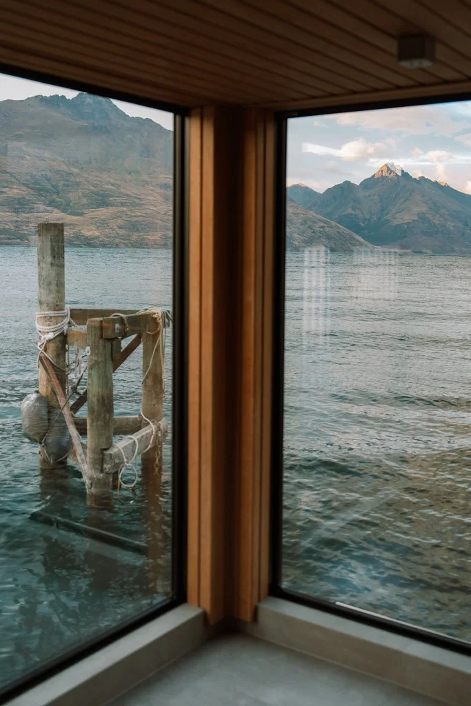 Large sauna windows look out across the lake in Queenstown