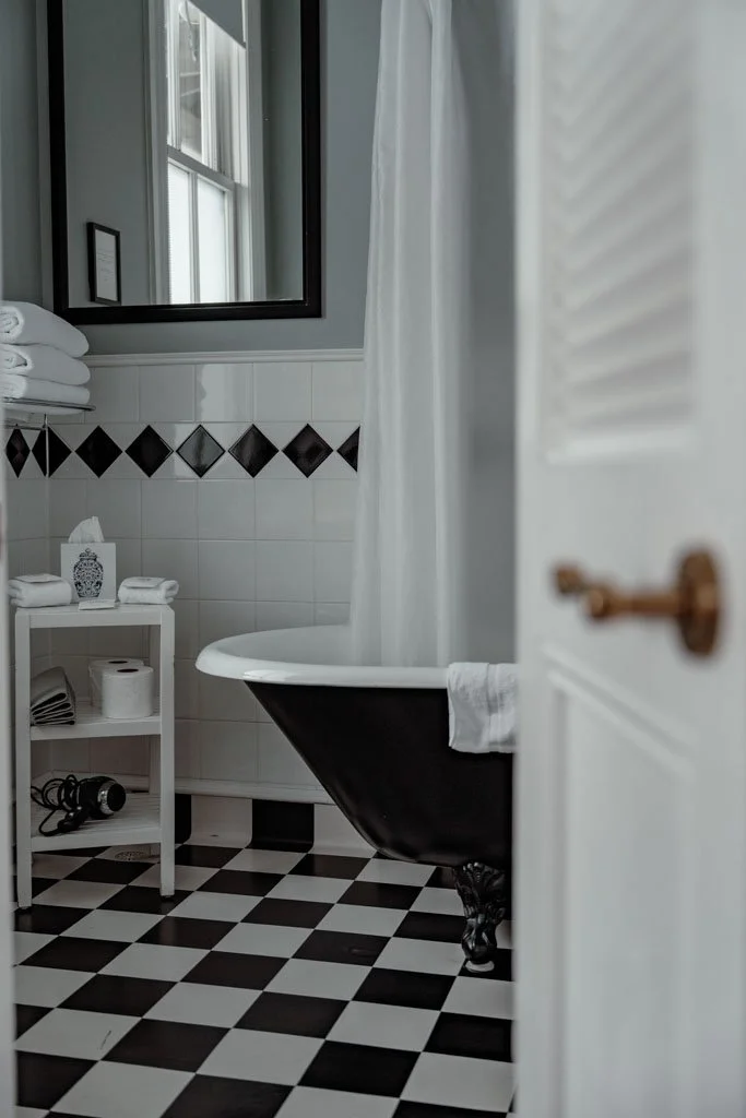 A tiled bathroom and claw foot tub at the Martinborough Hotel