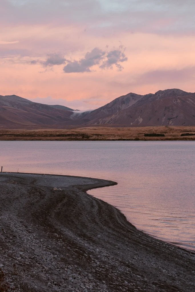 Pastel skies reflected in the blue water of Lake Tekapo