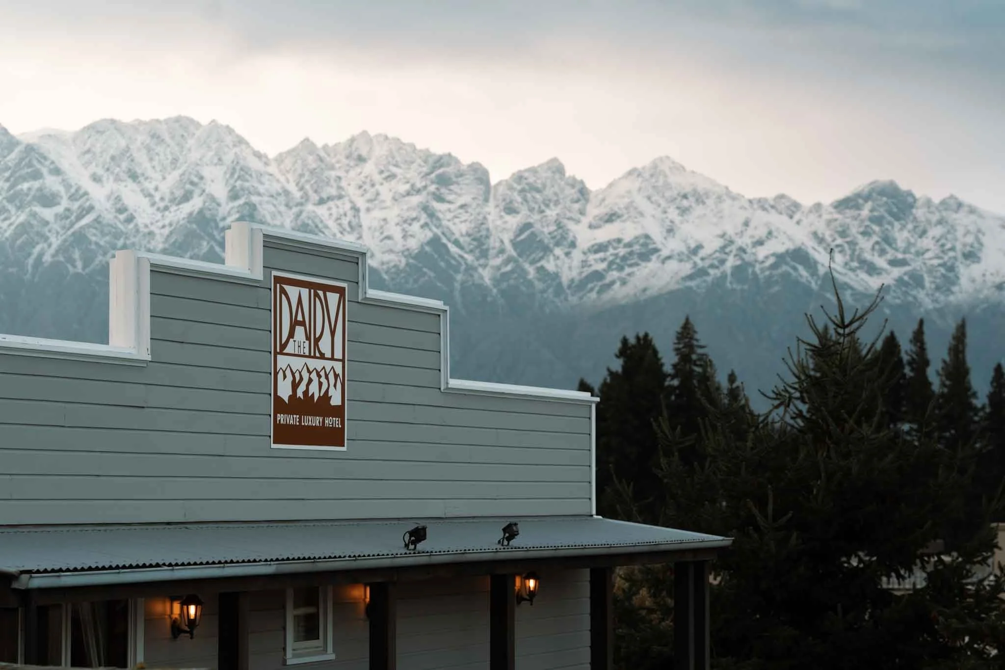 The front of the Dairy Hotel in Queenstown, with snowy mountains visible in the background