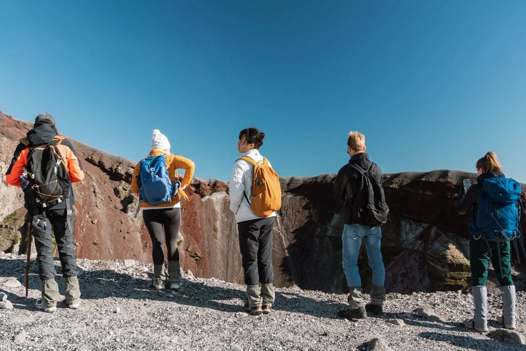 Hikers stand on the edge of Mt Tarawera's crater