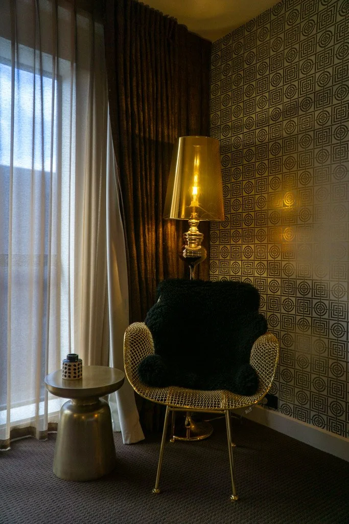 A gilt chair and lamp in the QT Hotel Wellington