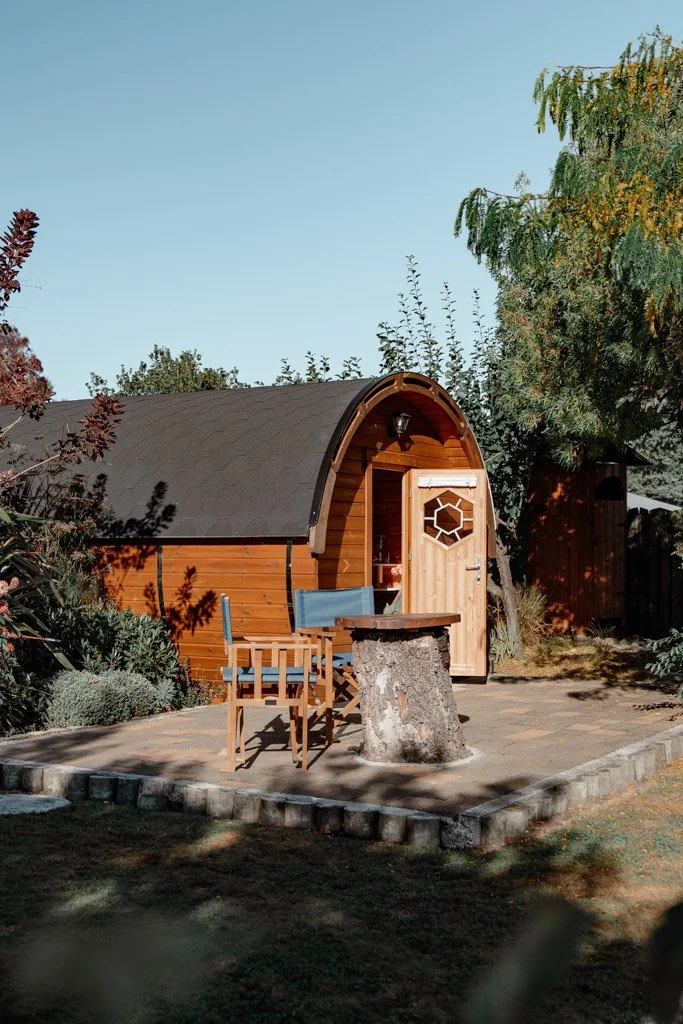 A wine barrel cabin surrounded by a garden in Marlborough