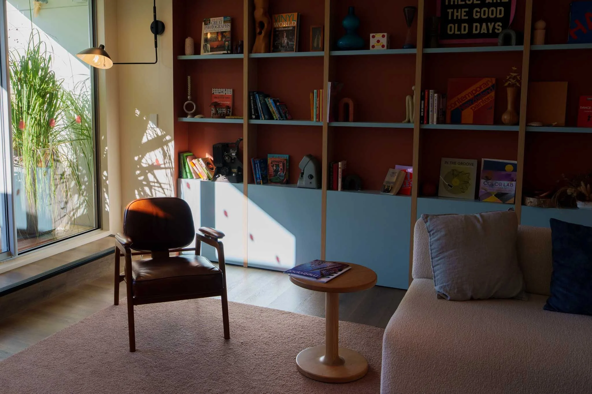 A library space filled with sunlight at Drifter hotel in Christchurch