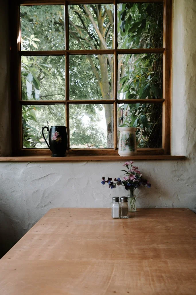 A table with a vase of fresh flowers at the Cardrona Hotel