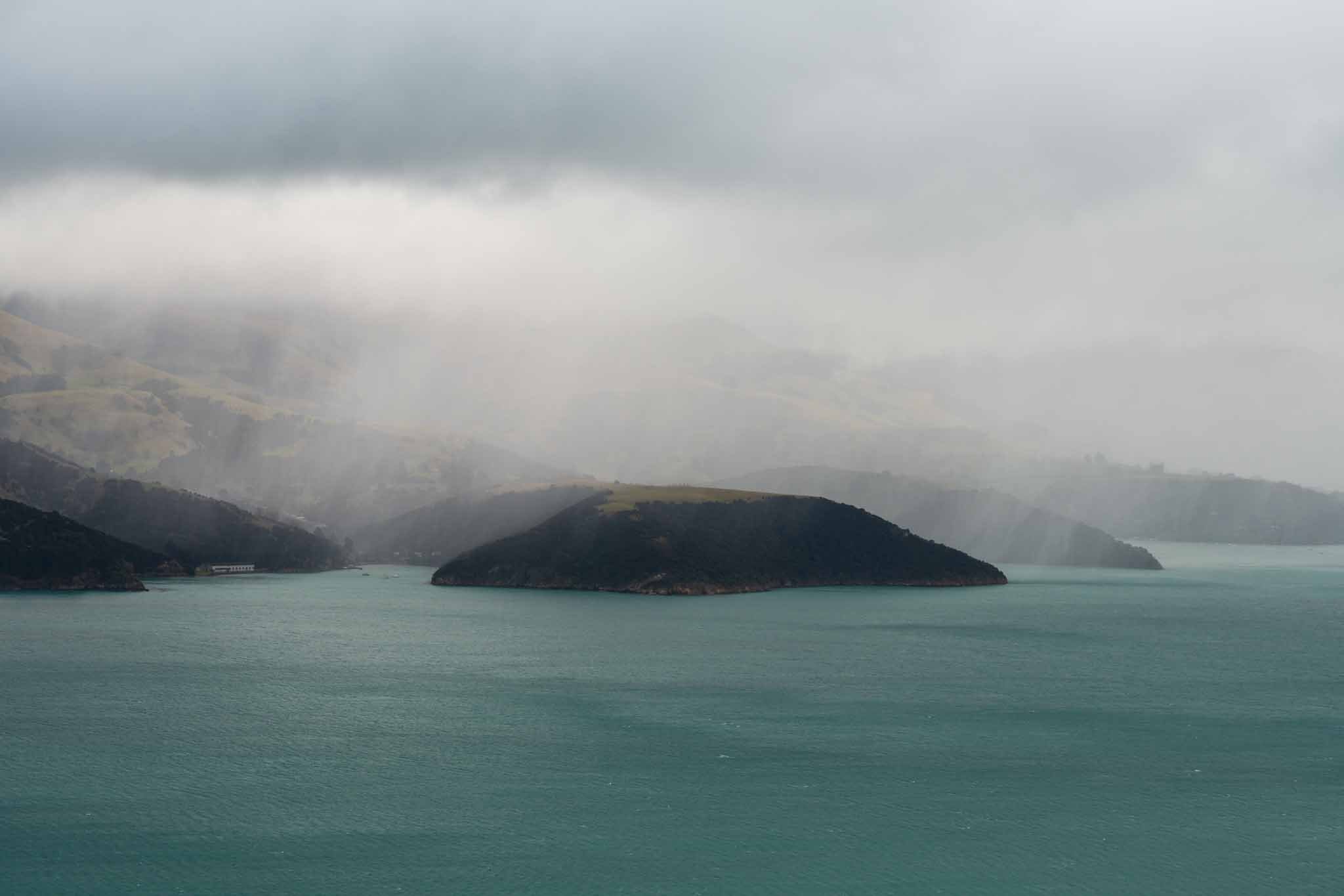 Rain clouds drift over the sea cliffs on Banks Peninsula