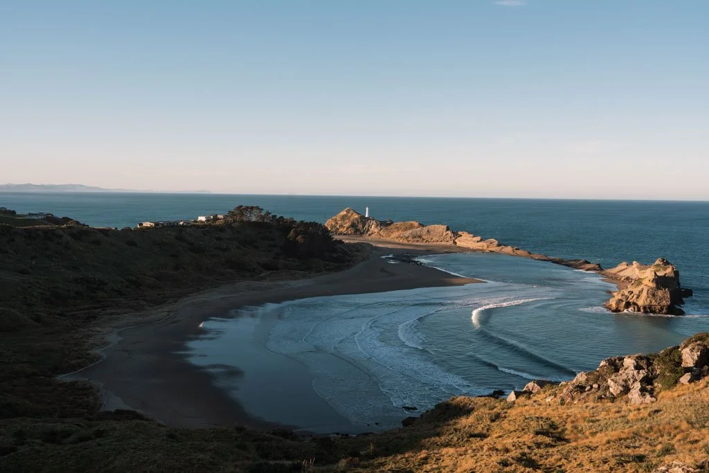 A horseshoe shaped bay is surrounded by rocky reefs