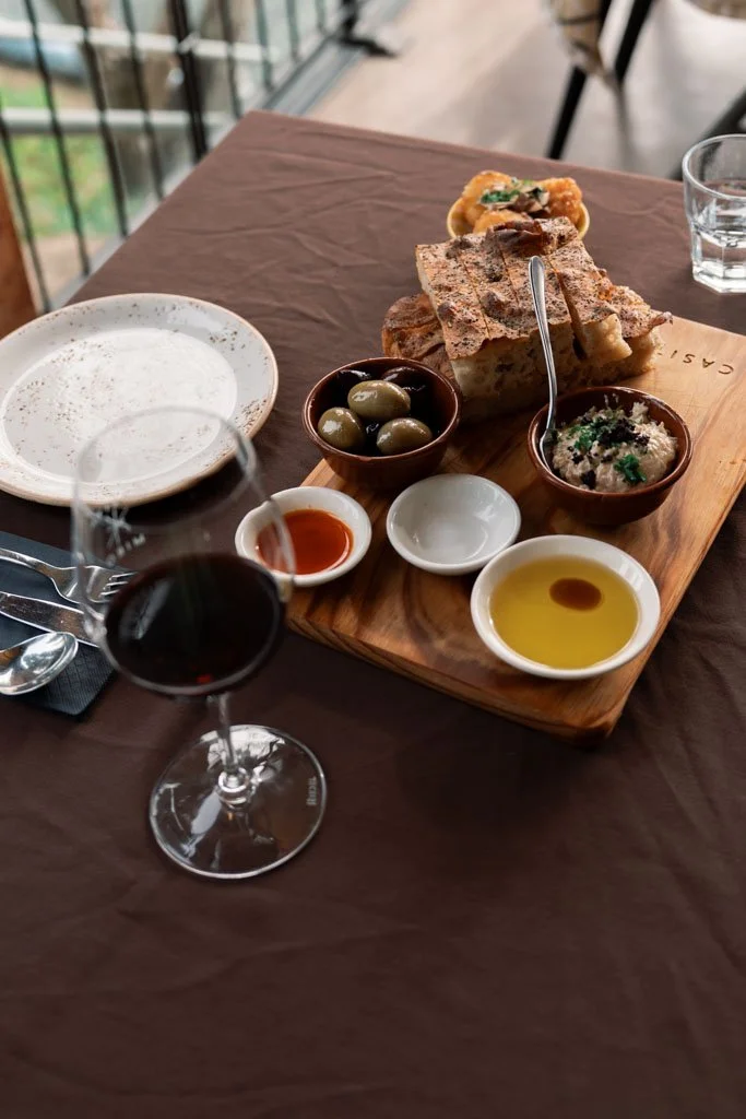 At Casita Miro wine sits next to a platter of olive oil and bread