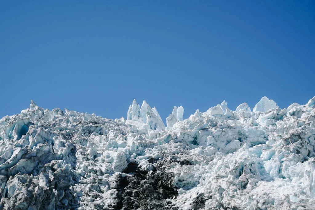 Glacial ice on Franz Josef set against a blue sky